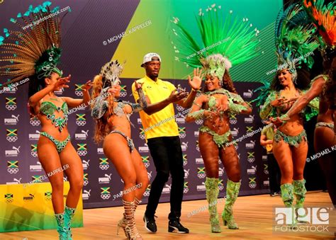 Athlete Usain Bolt C Of Jamaica Dances With Samba Dancers During A Press Conference Of The