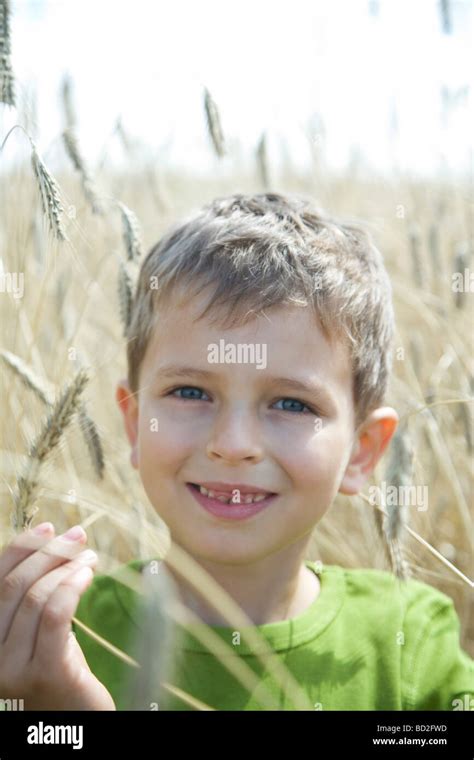Boy Walking On Wheat Field Stock Photo Alamy