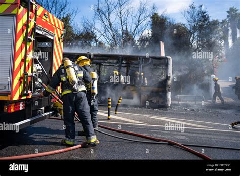 Rescue Team Of Firefighters Arrive On The Car Crash Fired Passenger Bus