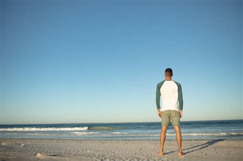 Free Photo Man Standing On The Beach