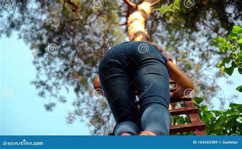 Woman Climbing On High Wooden Ladder Outdoor Legs And Visible Stock