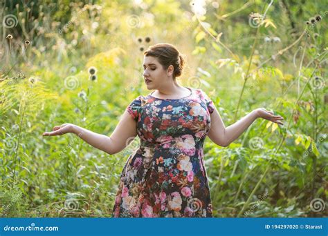 plus size fashion model in floral dress outdoors beautiful fat woman with big breasts in nature