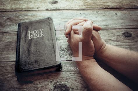 Praying Hands And A Bible — Photo — Lightstock