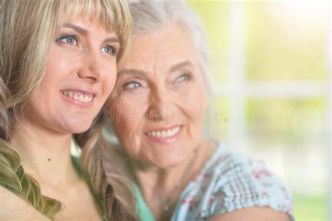 mature woman embracing with adult daughter at home stock image image of daughter