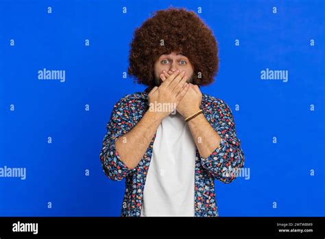 I will not say anything. Frightened man closing mouth with hands