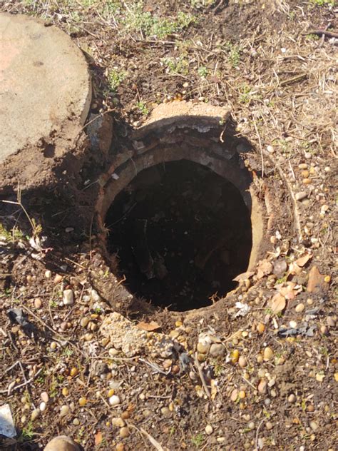 Large Hole In My Yard With A Large Pipe In The Side Something Water