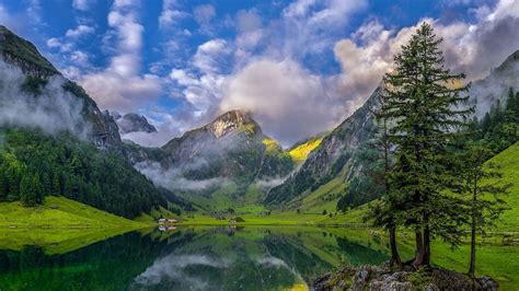 Beautiful Landscape View Of Mountains Surrounded By Fog Under Cloudy