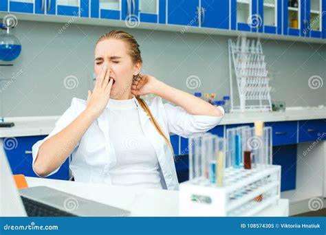 Young Chemistry Teacher In School Laboratory Workplace Yawning Stock