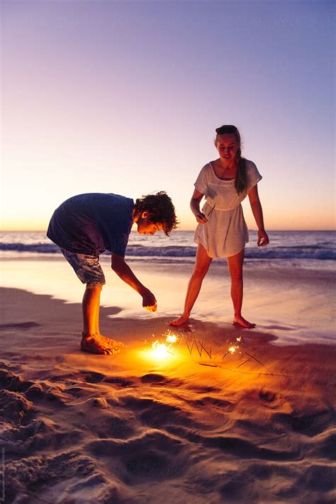 Brother And Sister With Sparklers At The Beach At Night By Stocksy Contributor Angela Lumsden