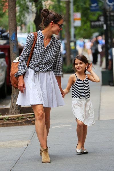 Holmes shared a black and white photo of suri laughing and smiling while playing with a young child. Katie Holmes Can Lean With Sheryl Sandberg, Too -- The Cut
