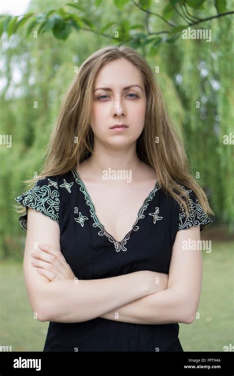 Serious Young Woman Arms Folded Outdoors Stock Photo Alamy