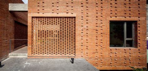 Perforated Brick Screens Create Private Space Amidst Busy Bangkok Streets