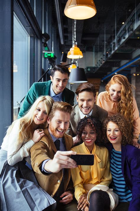 Happy Group Of Friends Taking A Selfie Del Colaborador De Stocksy