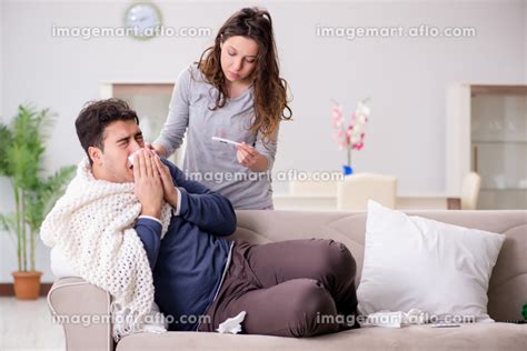 Wife Caring For Sick Husband At Home