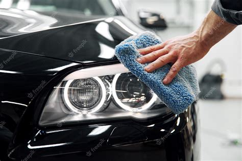 Premium Photo Car Detailing The Man Holds The Microfiber In Hand