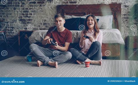 Cute Young Couple Boyfriend And Girlfriend Are Playing Videogame