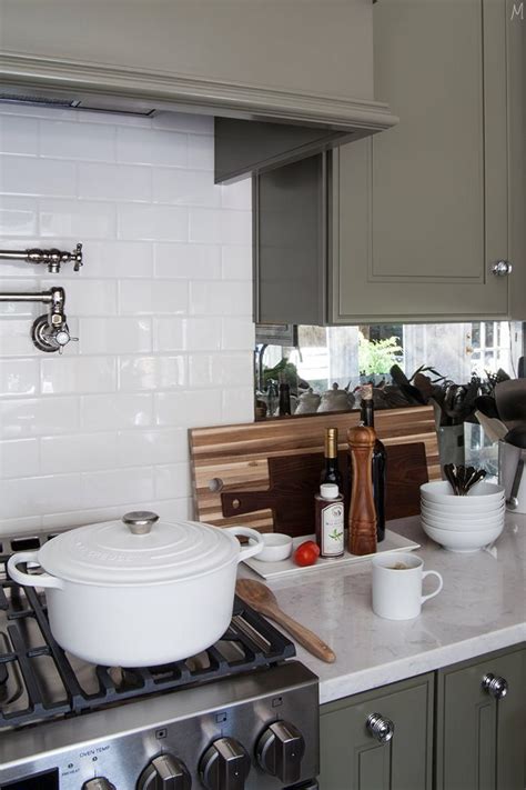 The mirrored tile backsplash contrasts nicely with the casual wicker stools. Mirrored Backsplash in the Kitchen | Backsplash, Beadboard ...
