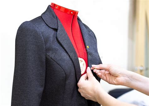 Fitting Clothes On A Mannequin In Atelier Tailors Hands With A Jacket