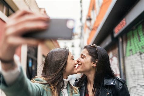 Lesbian Couple Taking Selfie By Stocksy Contributor Santi Nuñez Stocksy