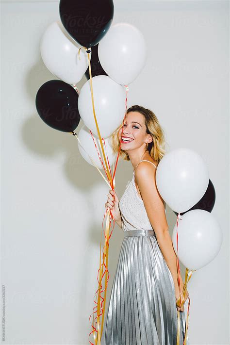Smiling Beautiful Woman Holding Balloons In A New Year Party