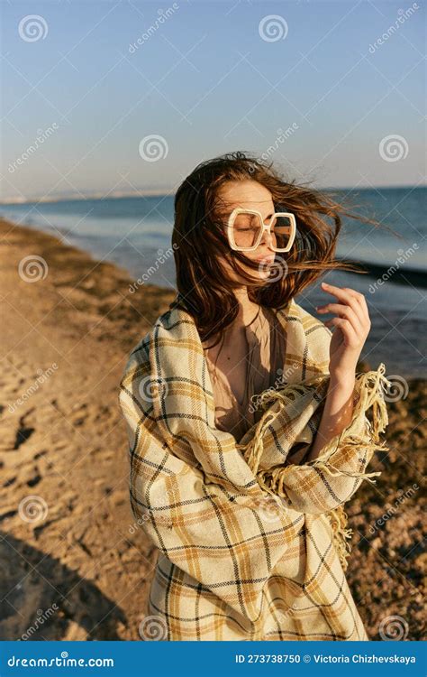 Portrait Of A Woman In A Blanket Standing On The Shore And
