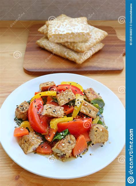 Vegetables Salad And Roasted Tempeh Cubes With Stack Of Fresh Tempeh In