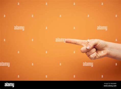 Gesture Female Index Finger Shows In Side Isolated On Orange