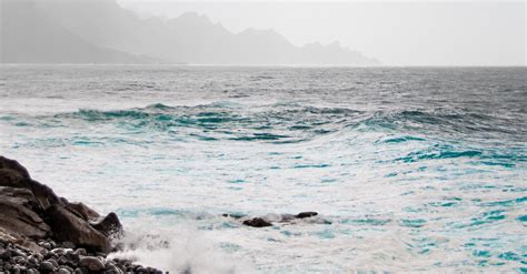 Stormy Sea Waving Near Stony Shore · Free Stock Photo