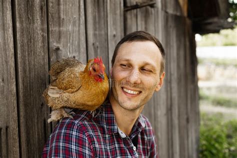 The Farmer Hugs A Chicken Pleasant Man Is Hugging A Cock Close Up Shot Emotions Stock Photo