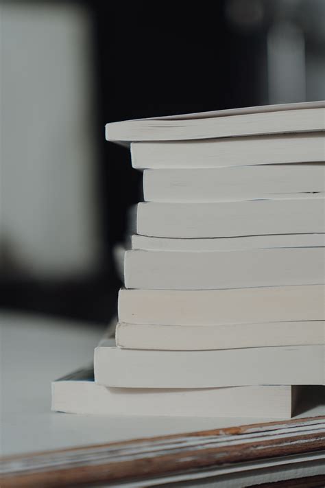 Stack Of White Books On White Table · Free Stock Photo