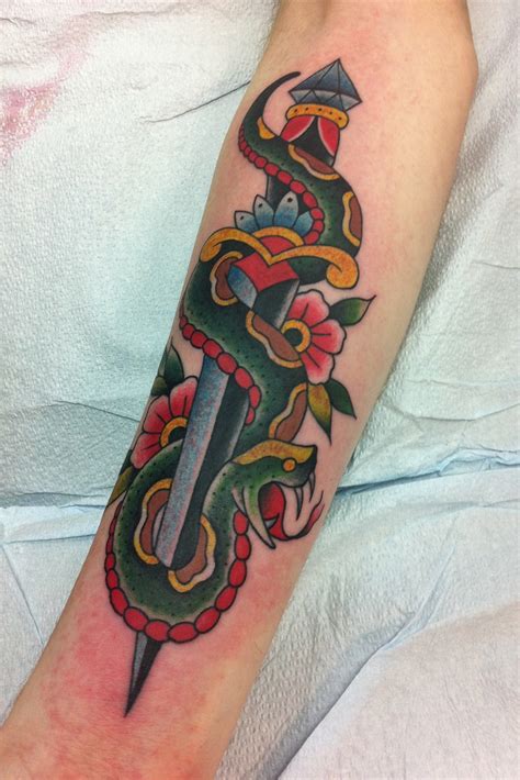 A dagger snake tattoo would look incomplete without the addition of venomous teeth. Snake & Dagger Tattoo - a photo on Flickriver