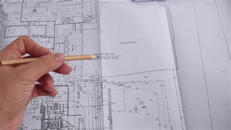 Macro Close Up Of Quantity Surveyors Hand Reviewing Technical Drawing