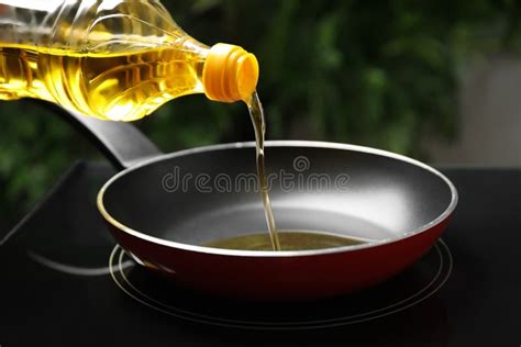 Pouring Cooking Oil From Bottle Into Frying Pan Closeup Stock Image Image Of Yellow Healthy