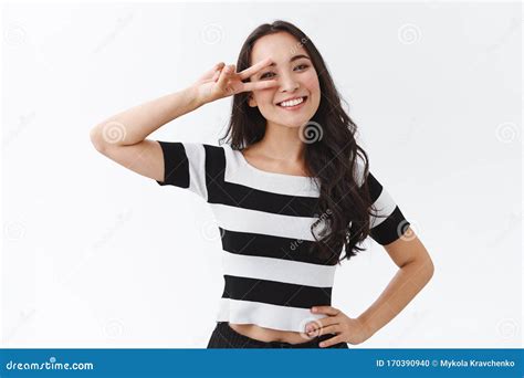 Optimistic Cheerful Young Asian Woman In Striped T Shirt Staying