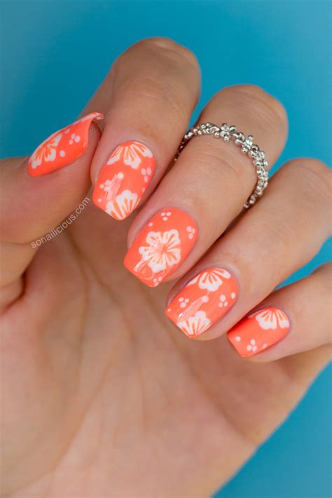 Whether done freehand with a brush or with the help of stamps, a floral effect is surprisingly easy — and always lovely. Hawaiian Flower Nail Art Tutorial