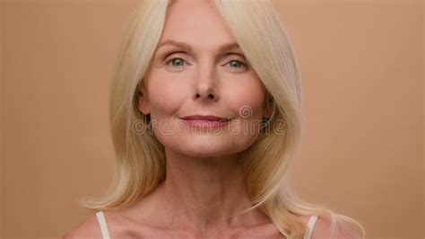 Beautiful Caucasian Mature Senior Middle Aged Woman In Beige Studio