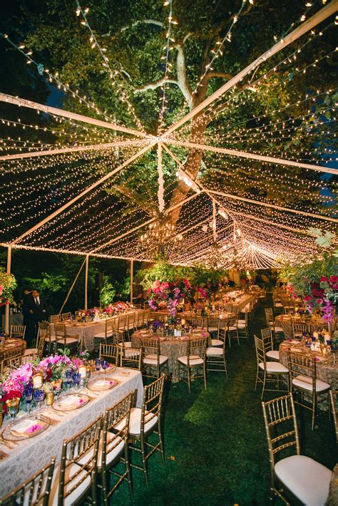 If you're hosting an outdoor wedding, have fairy lights cascading overhead to give off a romantic vibe. 15 Best Ideas of Hanging Lights for Outdoor Wedding