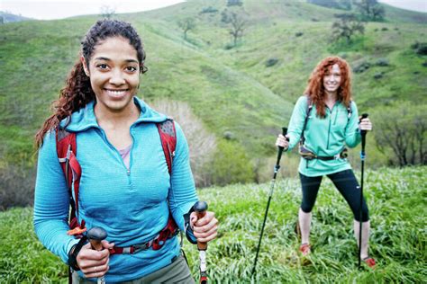 Portrait of smiling women hiking with walking sticks - Stock Photo ...