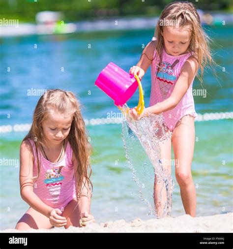 Adorable Little Girls Having Fun During Beach Vacation Stock Photo Alamy
