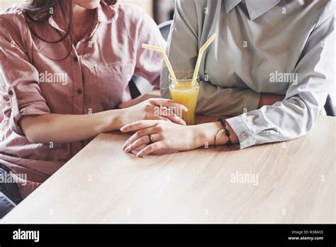 Two Beautiful Twin Girls Spend Time Drinking Juice Sisters Relaxing In A Cafe And Having Fun