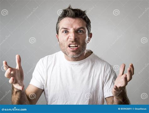 Young Attractive Man With Blue Eyes Looking Angry And Mad In Rage