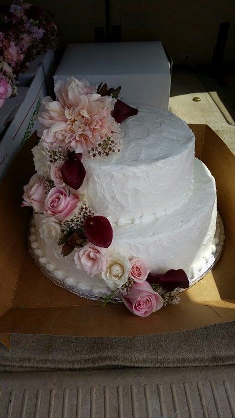 A copper and white marzipan layered cake by greta's cake corner is decorated with foraged berries, different shades of roses and marsala burgundy gerberas. Blush and burgundy cake flowers by Eden's Echo | Blush ...