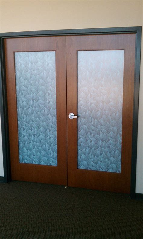 Some of your options include dressing each window separately, mounting your window coverings on the inside of the molding, or you can give plantation shutters a try. Decorative Window Film Transforms Plain Office Doors