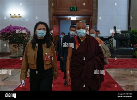A Tibetan Monk And Delegates Wearing Face Masks Leave After Attending