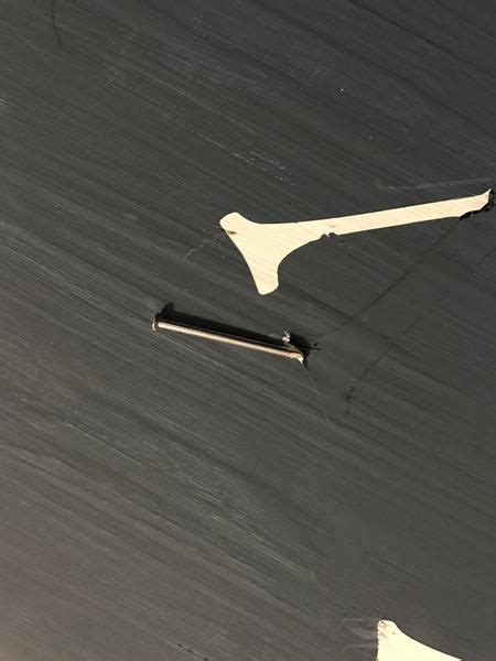 A Knife Is Laying On The Floor Next To A Piece Of Paper That Has Been