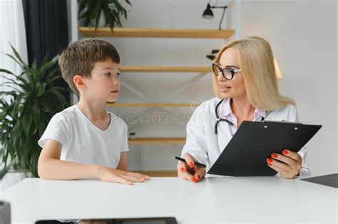 Smiling Young Female Doctor Or Pediatrician Talk Comfort Small Boy