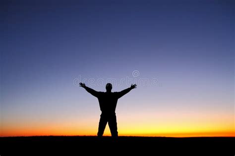 Silhouette Of Man With Arms Outstretched At Sunset Stock Image Image