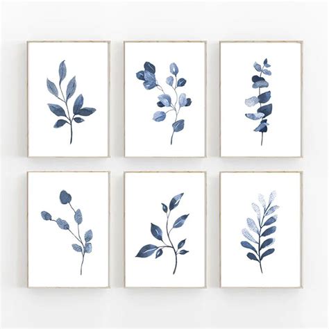 Four Blue Watercolor Paintings On White Paper Each With Different