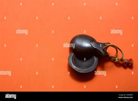 Close Up Of Some Traditional Dark Wood Castanets Of Spanish Music On An Orange Background With