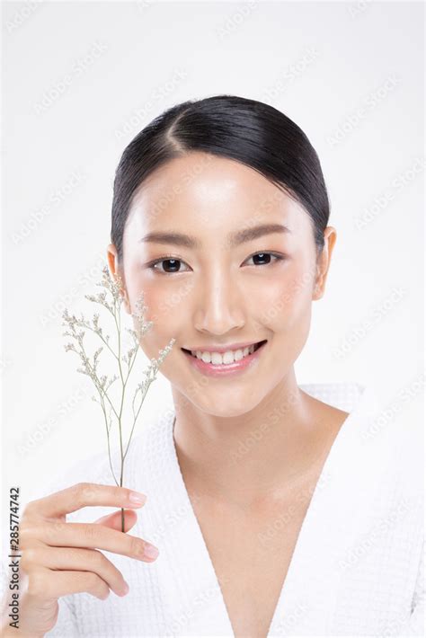 beautiful asian woman looking at camera smile with clean and fresh skin happiness and cheerful